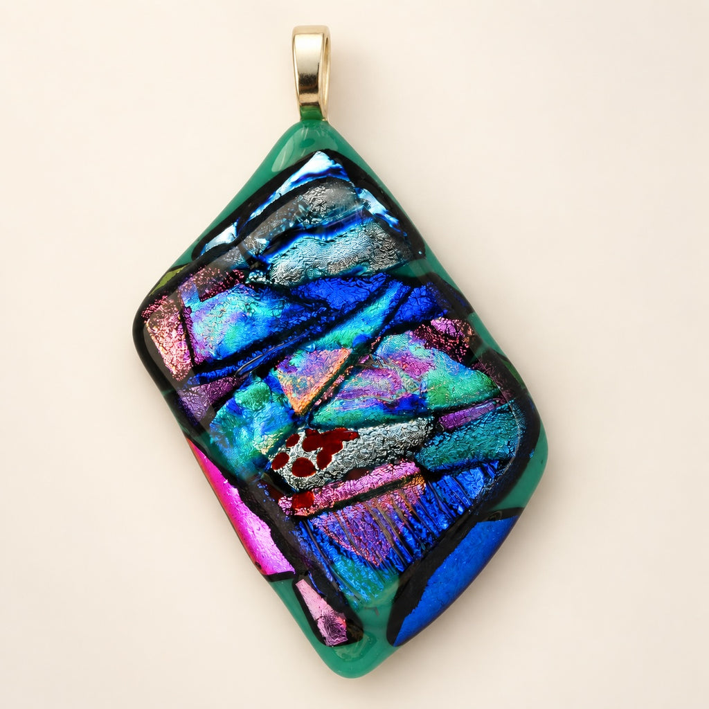 Handmade glass abstract pendant; each is unique.