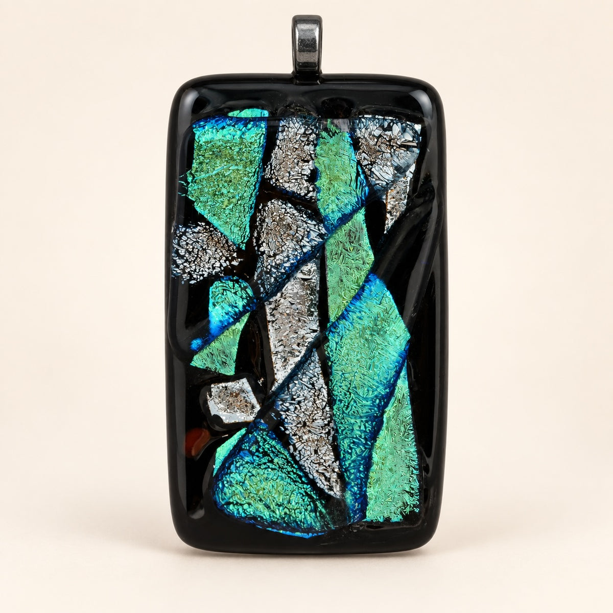 Handmade glass abstract pendant; each is unique.