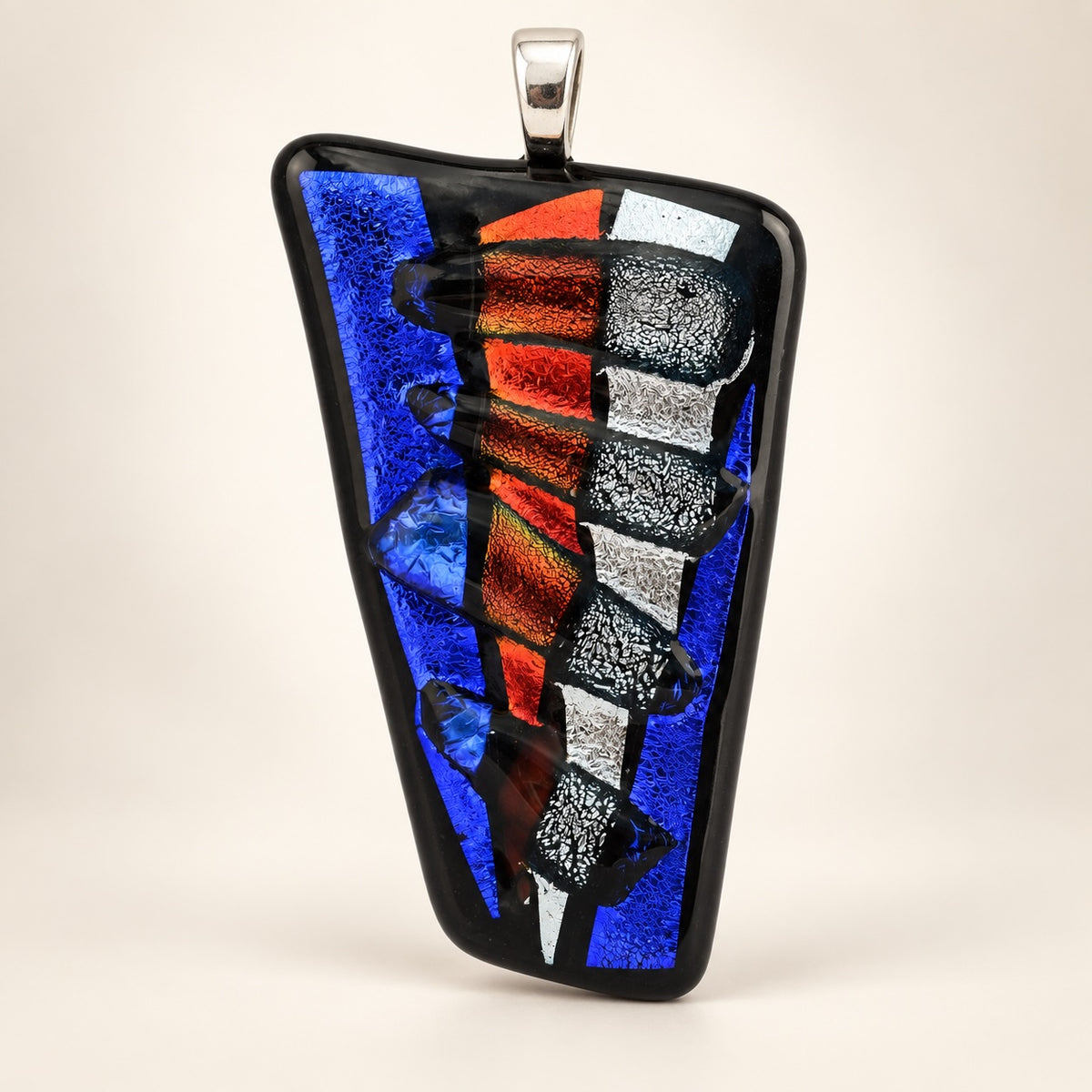 Handmade glass abstract pendant; each is unique.